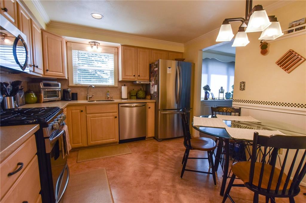 260 Fisher Road Saxonburg, PA 16056 - Photo 5 of 19 a kitchen with a table chairs refrigerator and cabinets