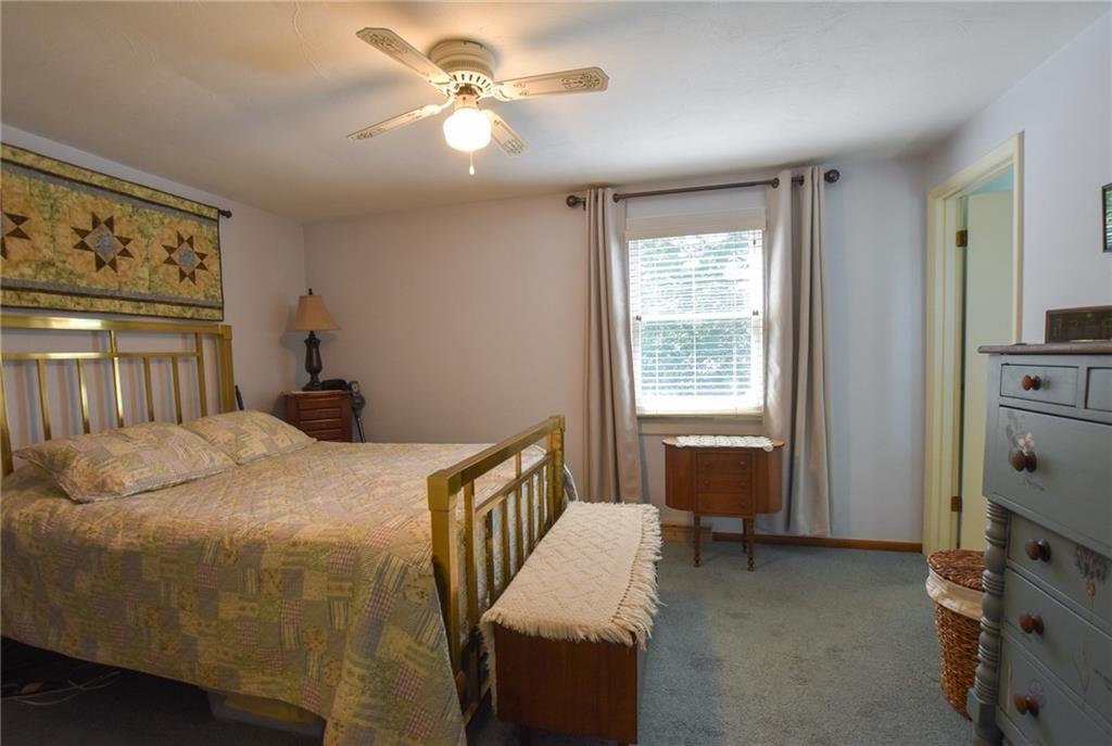 260 Fisher Road Saxonburg, PA 16056 - Photo 7 of 19 a bedroom with a bed and a chandelier
