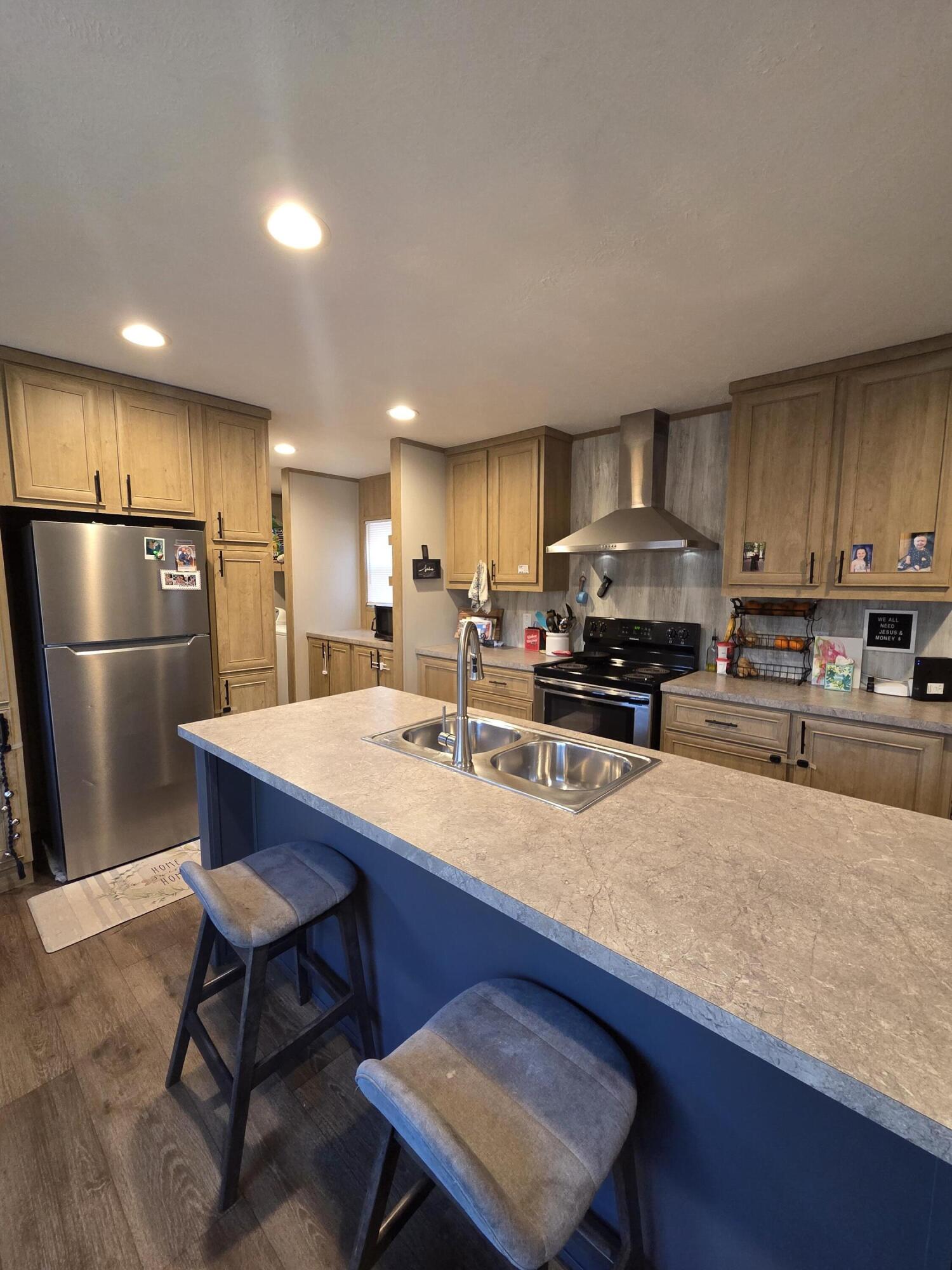 625 Jamestown Road Rocky Mount, VA 24151 - Photo 4 of 11 a kitchen with stainless steel appliances a refrigerator a stove a sink a stove a dining table and chairs