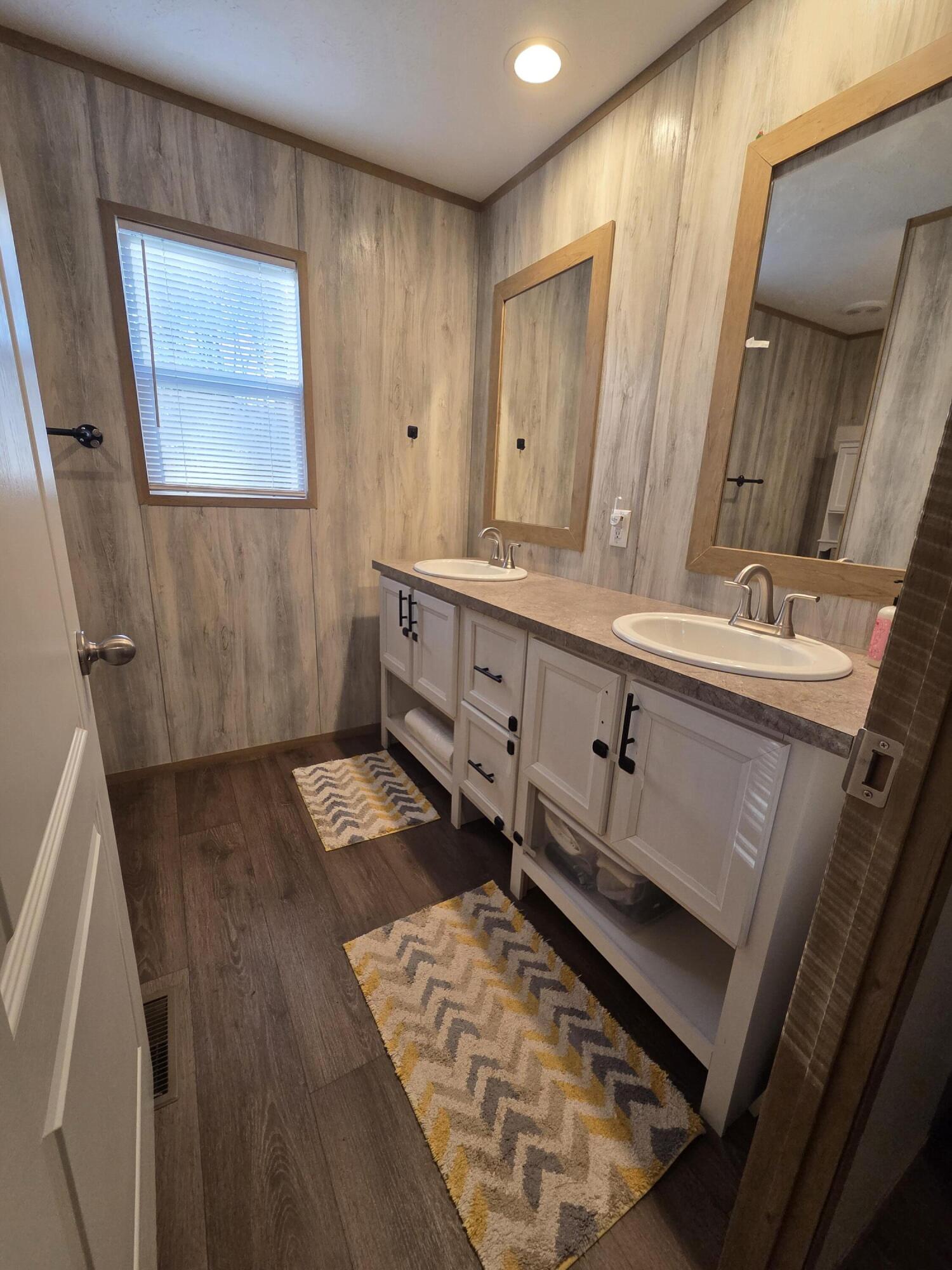 625 Jamestown Road Rocky Mount, VA 24151 - Photo 9 of 11 a bathroom with a double vanity sink a toilet and a mirror