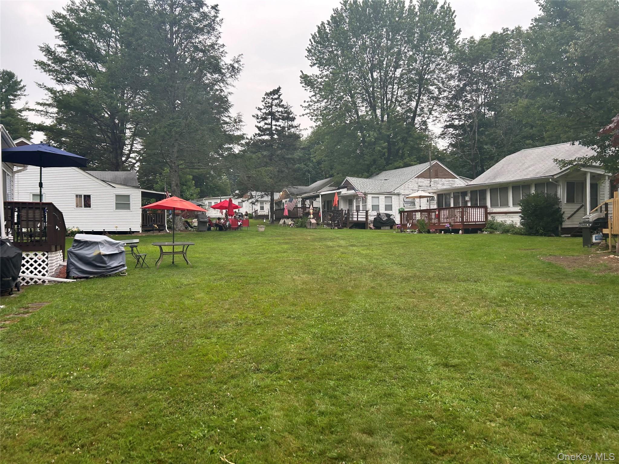 a view of a house with a yard and sitting area
