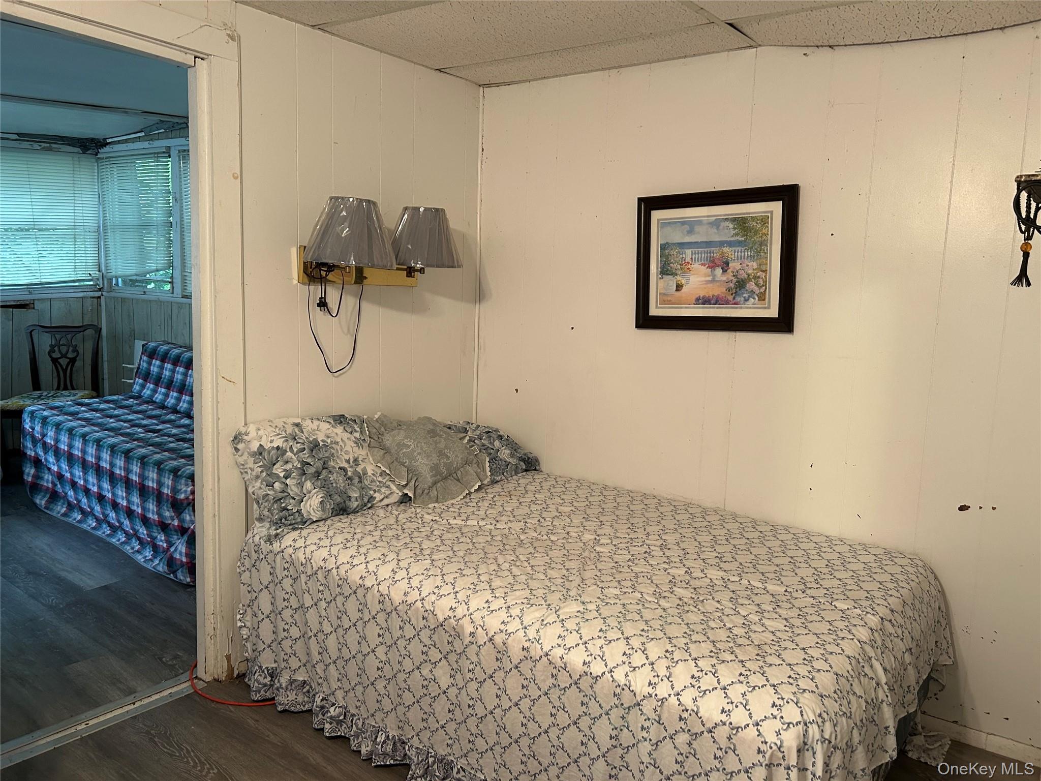 52 Greentree Road, Unit 12A Monticello, NY 12701 - Photo 5 of 11 a bedroom with a bed and wall painting