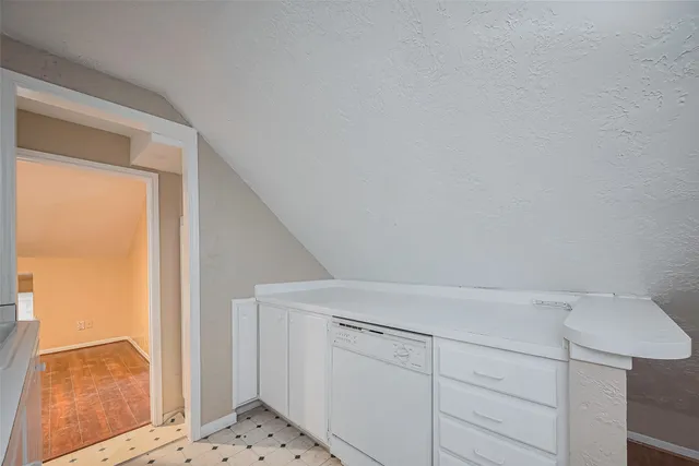 a view of hallway with wooden floor