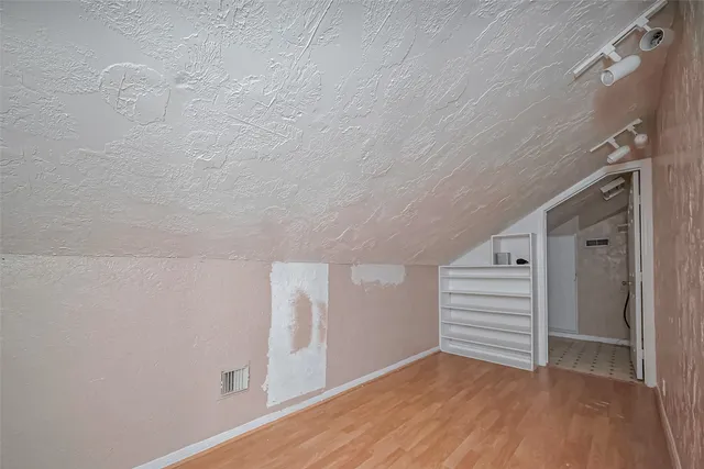 a view of room with stairs and a hardwood floor