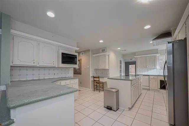 a kitchen with a sink appliances and cabinets