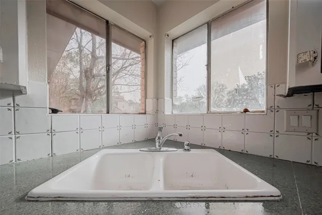 a bathroom with mirror a window and a bathtub