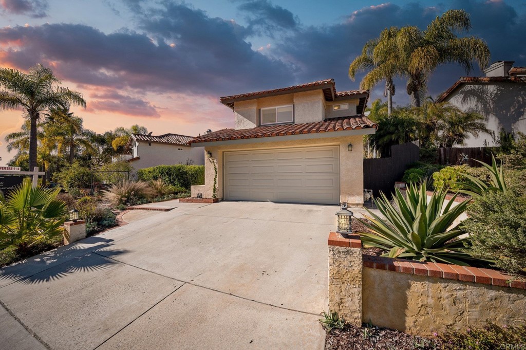 1740 Avenida Segovia Oceanside, CA 92056 - Photo 1 of 40 a front view of a house with a yard and garage