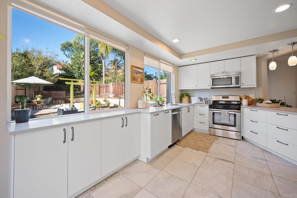 1740 Avenida Segovia Oceanside, CA 92056 - Photo 11 of 40 a kitchen with granite countertop cabinets and steel stainless steel appliances