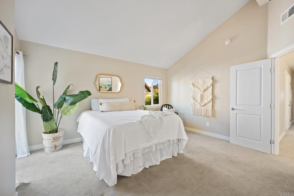 1740 Avenida Segovia Oceanside, CA 92056 - Photo 17 of 40 a bedroom with bed and a potted plant