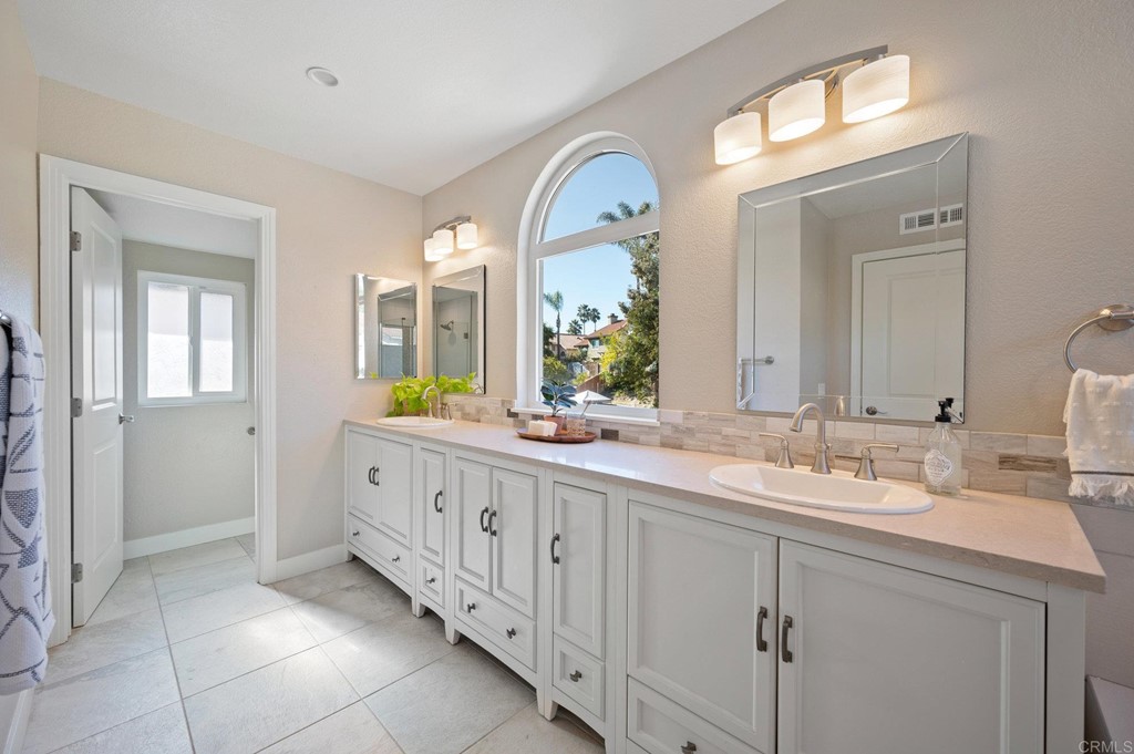 1740 Avenida Segovia Oceanside, CA 92056 - Photo 20 of 40 a spacious bathroom with a granite countertop sink mirror and a