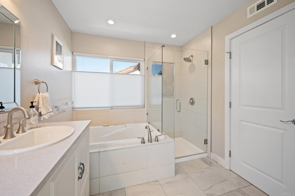 1740 Avenida Segovia Oceanside, CA 92056 - Photo 21 of 40 a bathroom with a tub sink and mirror