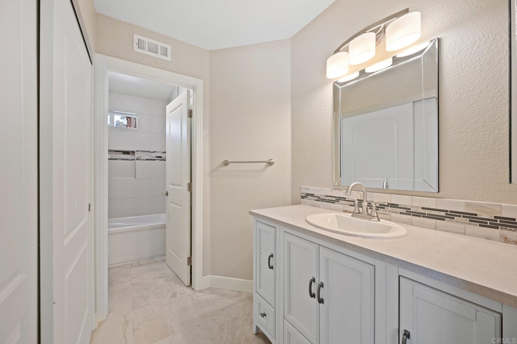 1740 Avenida Segovia Oceanside, CA 92056 - Photo 25 of 40 a bathroom with a sink and a mirror