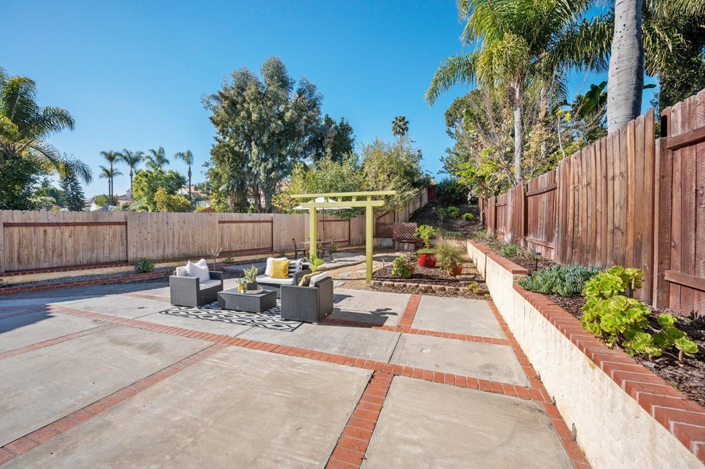 1740 Avenida Segovia Oceanside, CA 92056 - Photo 27 of 40 a view of a patio with a table and chairs with wooden fence