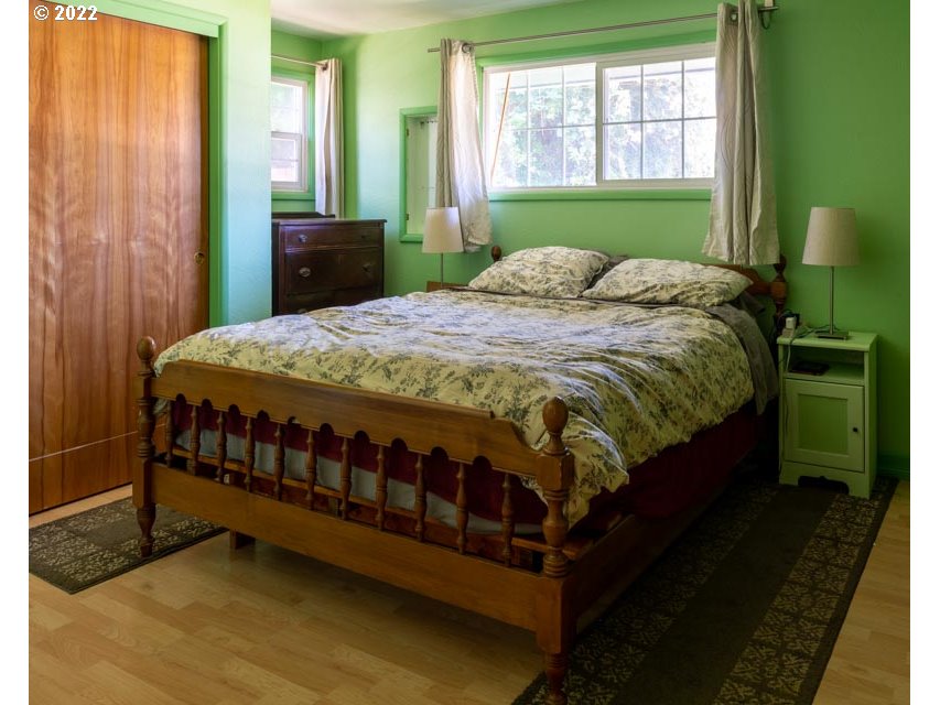 370 Lombard Lane Eugene, OR 97404 - Photo 12 of 19 a bed sitting in a bedroom next to a window