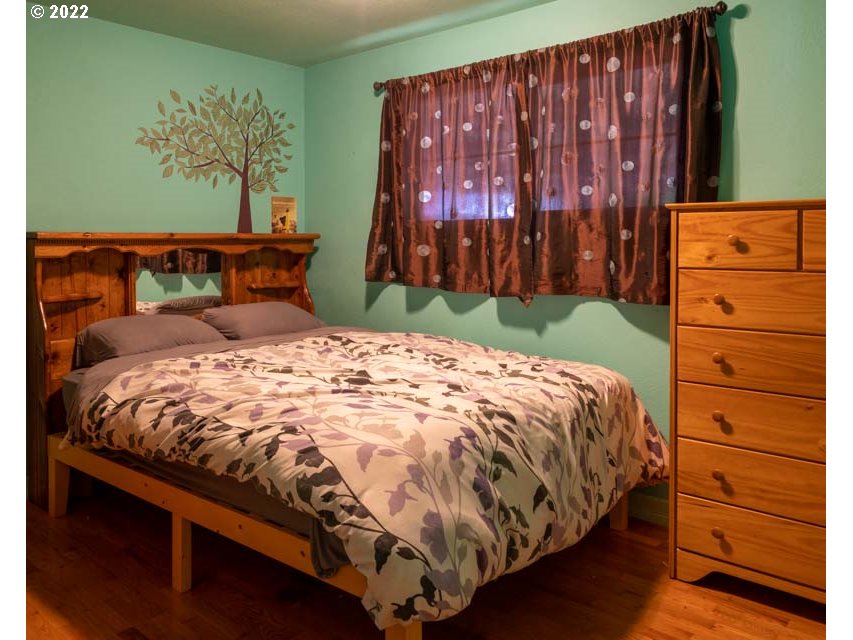 370 Lombard Lane Eugene, OR 97404 - Photo 15 of 19 a bed sitting in a bedroom next to a cabinet