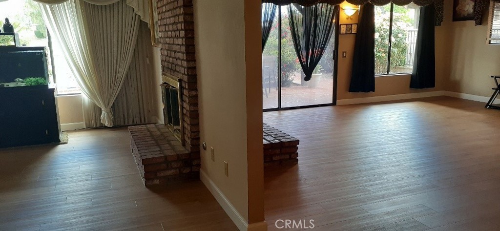 1484 Pepper Tree Drive Hemet, CA 92545 - Photo 10 of 29 Living rm & family double sided by fireplace