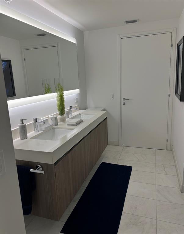 401 North Birch Road, Unit 1212 Fort Lauderdale, FL 33304 - Photo 11 of 40 a bathroom with a sink a vanity and a mirror