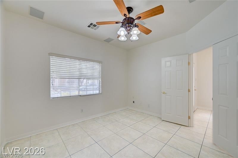 8918 Houston Ridge Avenue Las Vegas, NV 89178 - Photo 11 of 47 Spare room with a ceiling fan and light tile patterned floors