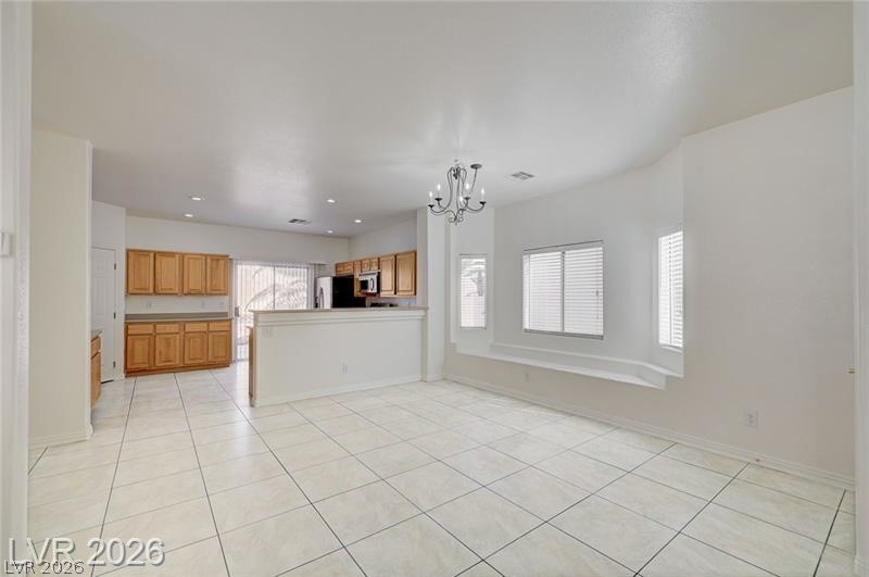 8918 Houston Ridge Avenue Las Vegas, NV 89178 - Photo 47 of 47 Kitchen featuring a peninsula, hanging lights, light tile patterned floors, and open floor plan