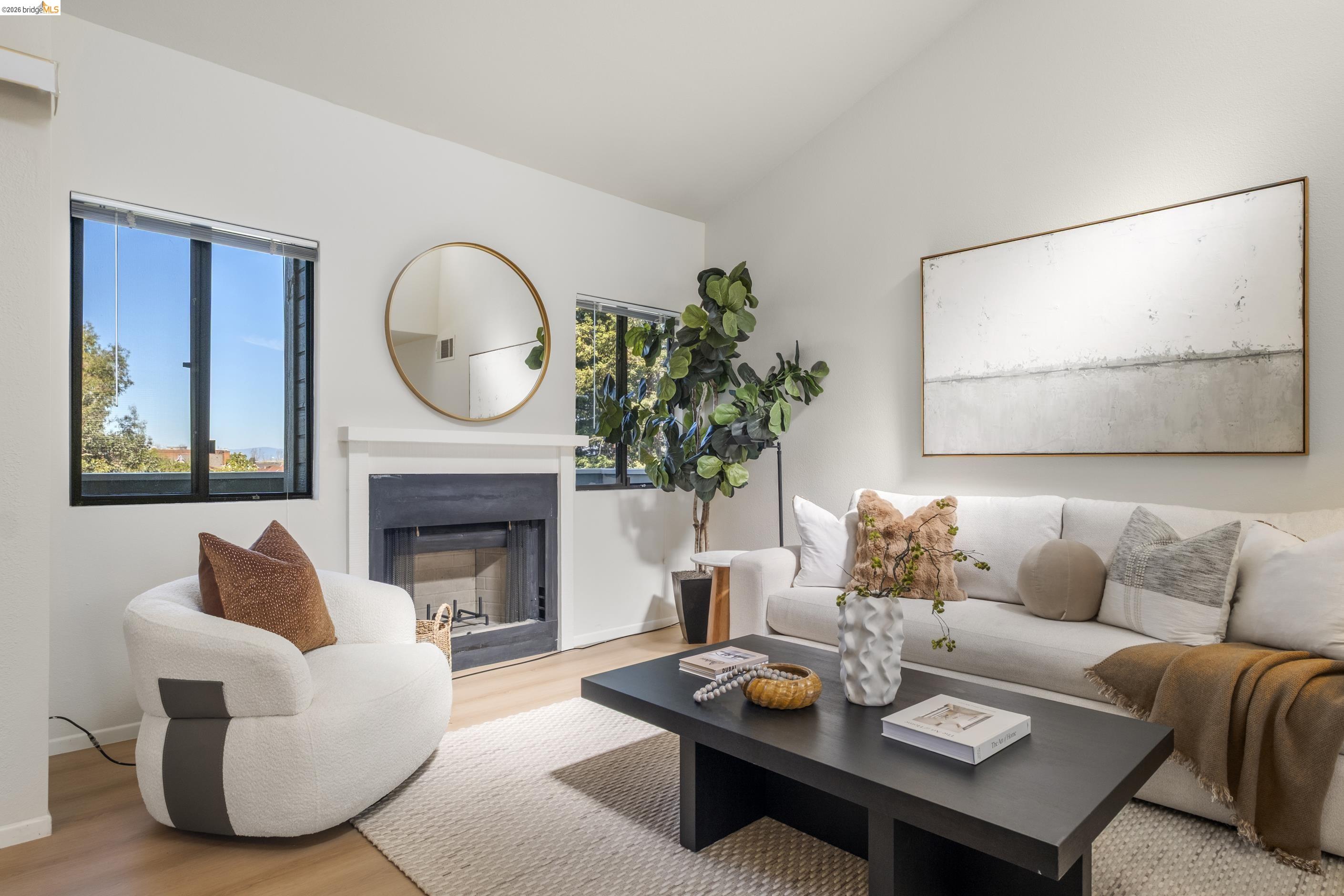 214 Apollo, Unit 3 Hercules, CA 94547 - Photo 9 of 26 Living room featuring wood finished floors, a fireplace, and lofted ceiling