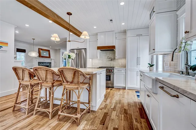 a view of a patio with couches table and chairs and potted plants