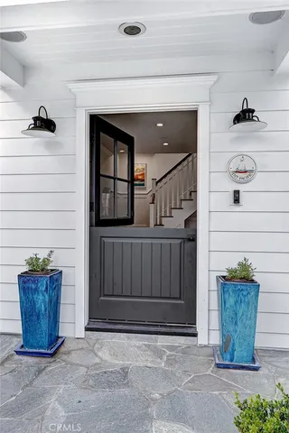 a kitchen with stainless steel appliances granite countertop a dining table chairs refrigerator and microwave