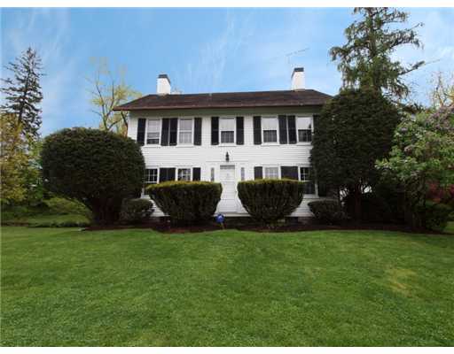 146 Goodwives River Road Darien, CT 06820 - Photo 1 of 13 a front view of a house with a garden and trees