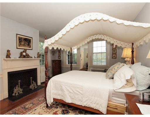 146 Goodwives River Road Darien, CT 06820 - Photo 12 of 13 a large bedroom with a bed and a fireplace