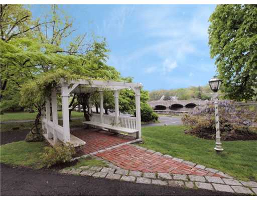 146 Goodwives River Road Darien, CT 06820 - Photo 6 of 13 a front view of a house with a yard