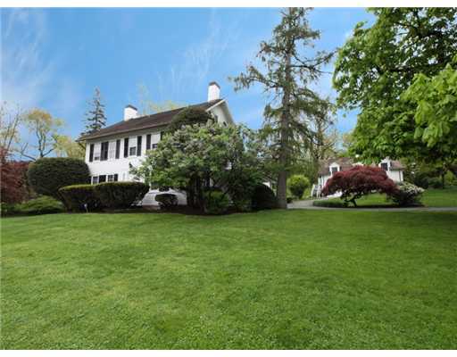 146 Goodwives River Road Darien, CT 06820 - Photo 7 of 13 a front view of a house with a garden