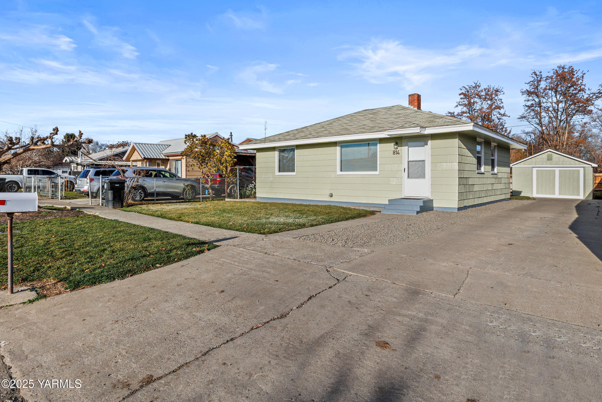 814 Adams Avenue Toppenish, WA 98948 - Photo 1 of 23 a front view of a house with a garden and trees
