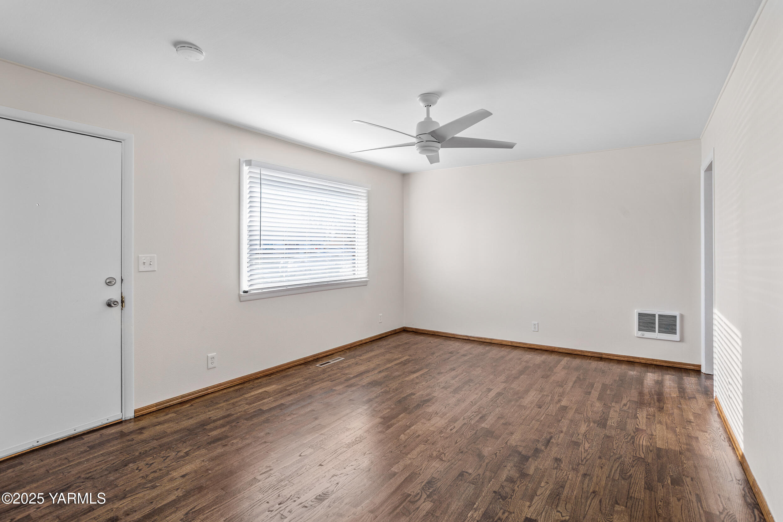 814 Adams Avenue Toppenish, WA 98948 - Photo 15 of 23 wooden floor in an empty room with a window