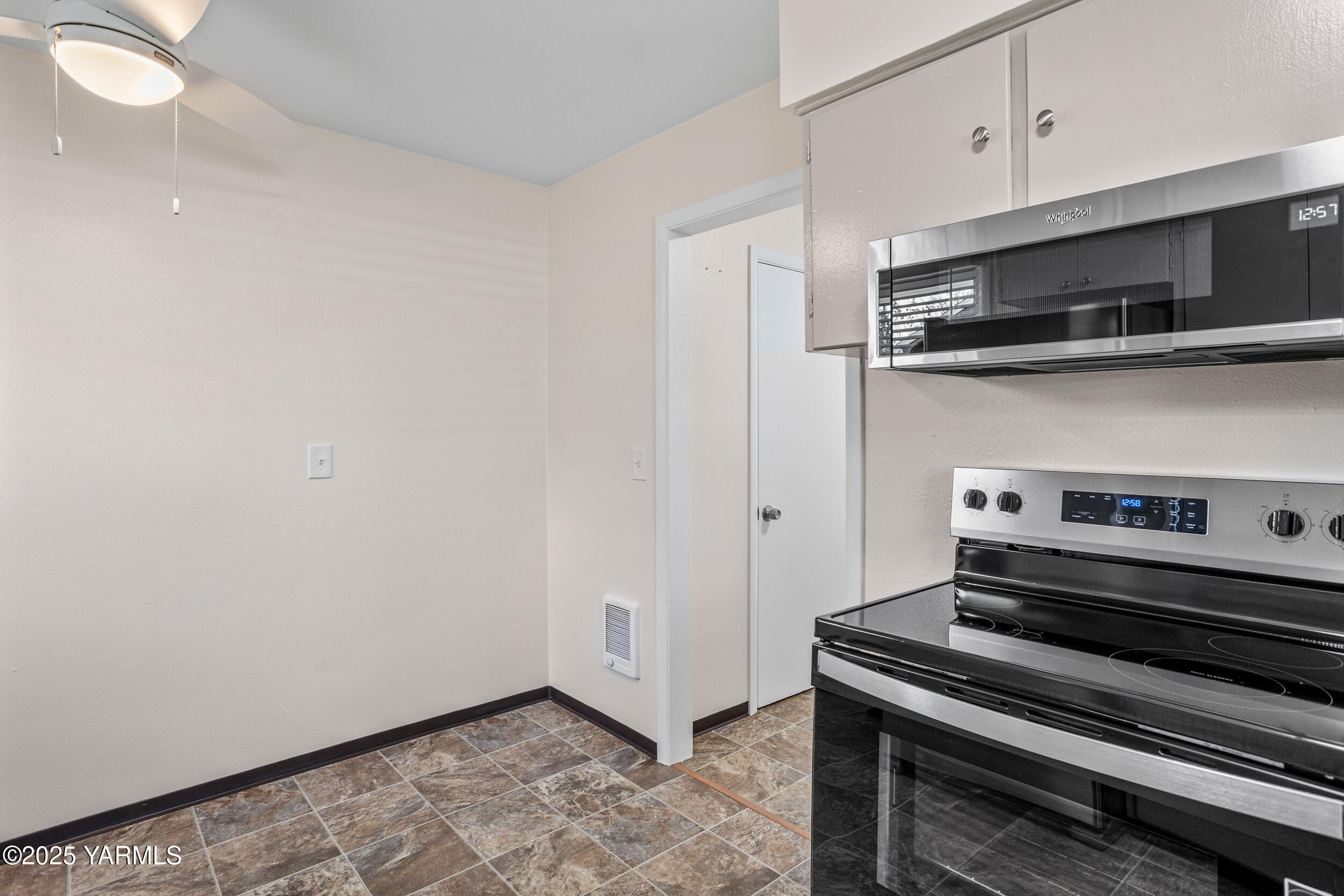 814 Adams Avenue Toppenish, WA 98948 - Photo 16 of 23 a kitchen with a stove and a microwave