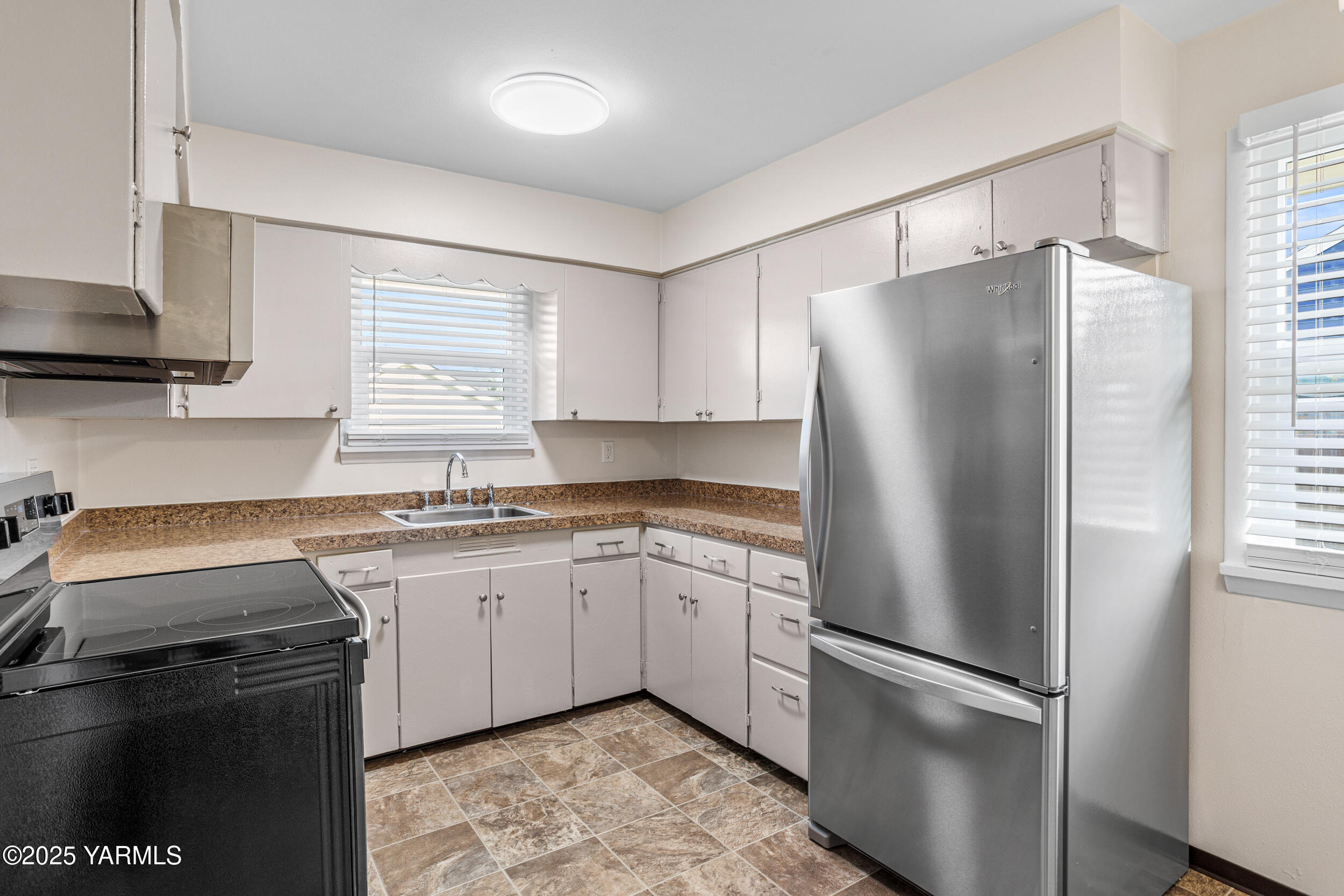 814 Adams Avenue Toppenish, WA 98948 - Photo 3 of 23 a kitchen with a refrigerator sink and cabinets