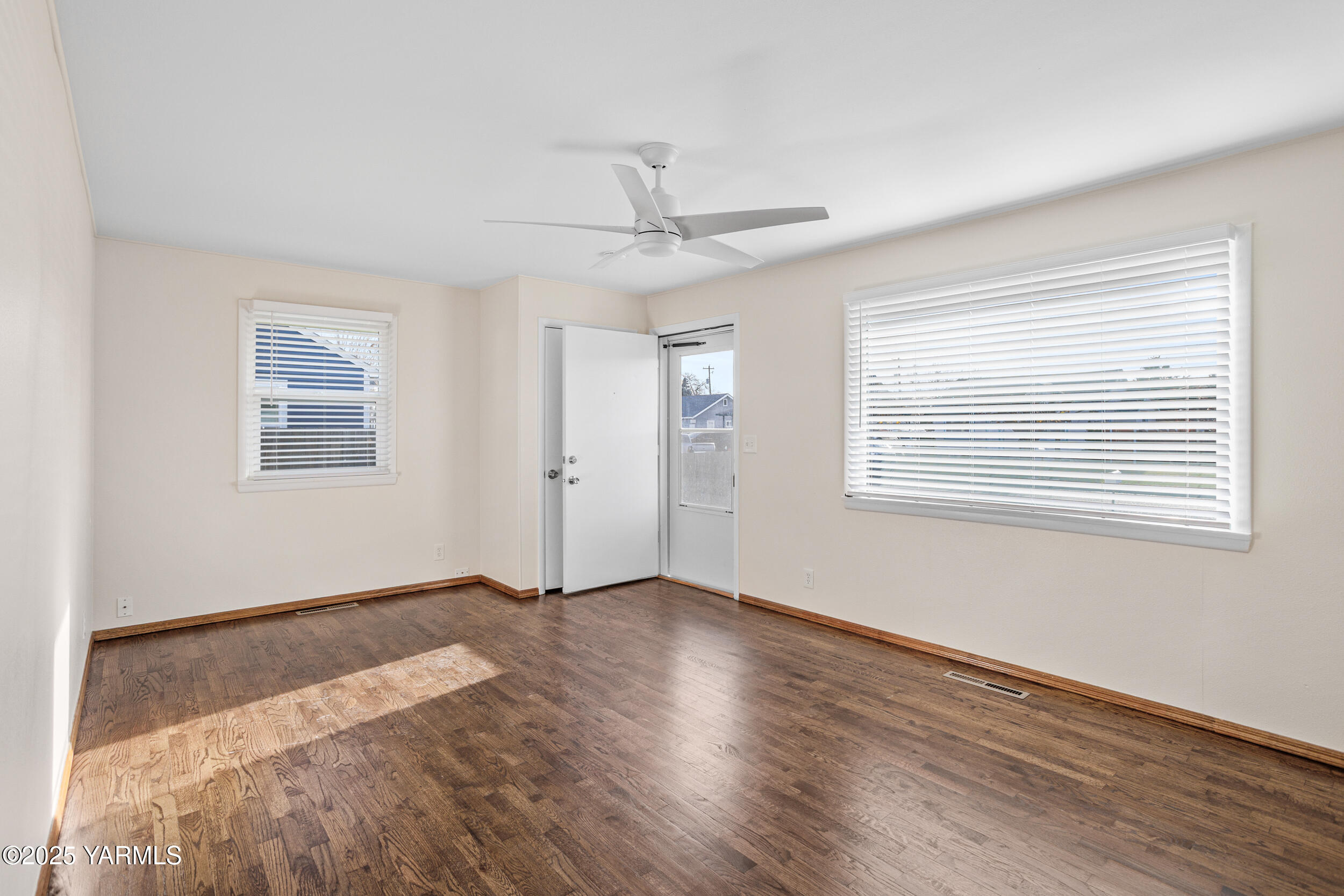 814 Adams Avenue Toppenish, WA 98948 - Photo 5 of 23 a view of an empty room with wooden floor and a window