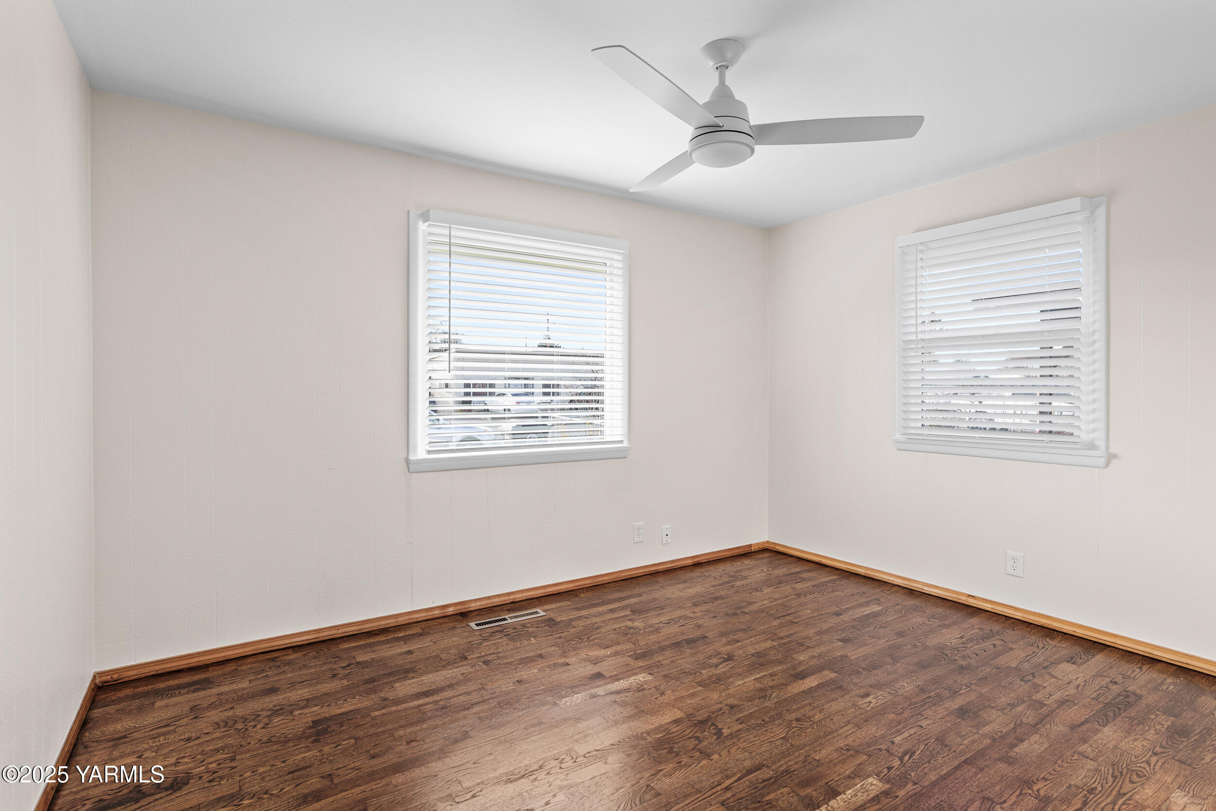 814 Adams Avenue Toppenish, WA 98948 - Photo 7 of 23 wooden floor in an empty room with a window