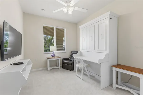 a bathroom with a granite countertop toilet sink and mirror