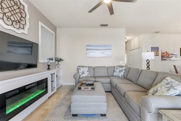 a living room with furniture and a fireplace