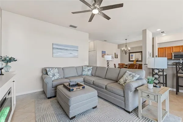 a living room with furniture and a chandelier