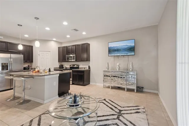a kitchen with stainless steel appliances kitchen island granite countertop a sink and cabinets
