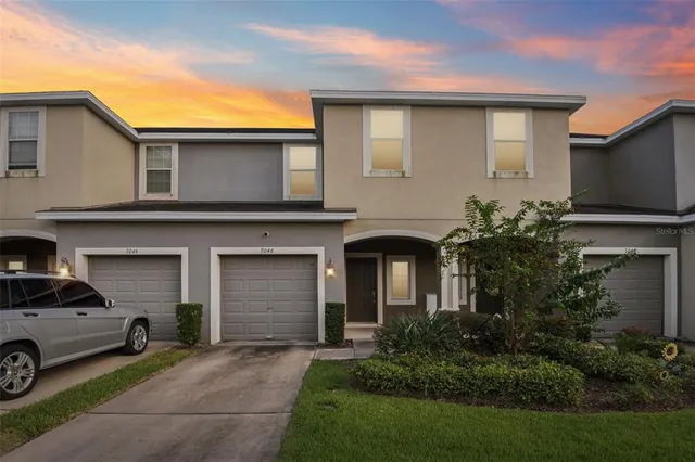 a front view of a house with a yard and garage
