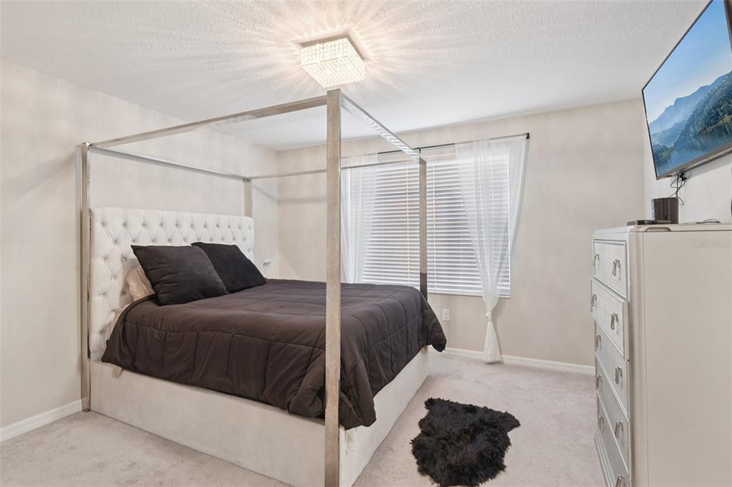 7046 Towne Lake Road Riverview, FL 33578 - Photo 25 of 47 a bedroom with a bed and a television