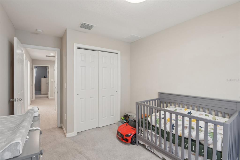 7046 Towne Lake Road Riverview, FL 33578 - Photo 29 of 47 a bedroom with bed and a chandelier fan