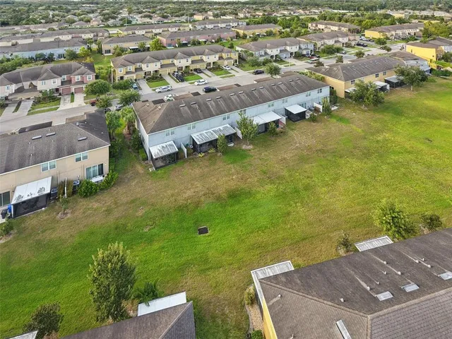 an aerial view of a house with a yard