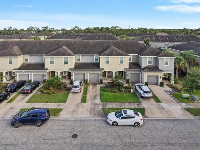 an aerial view of a house with car parked