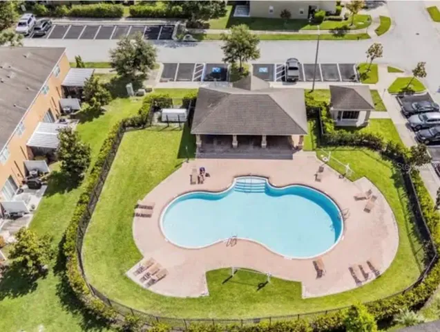 an aerial view of a house with swimming pool and outdoor space