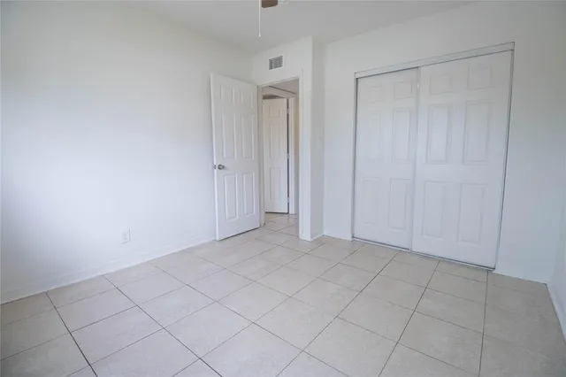 a view of an empty room and closet area