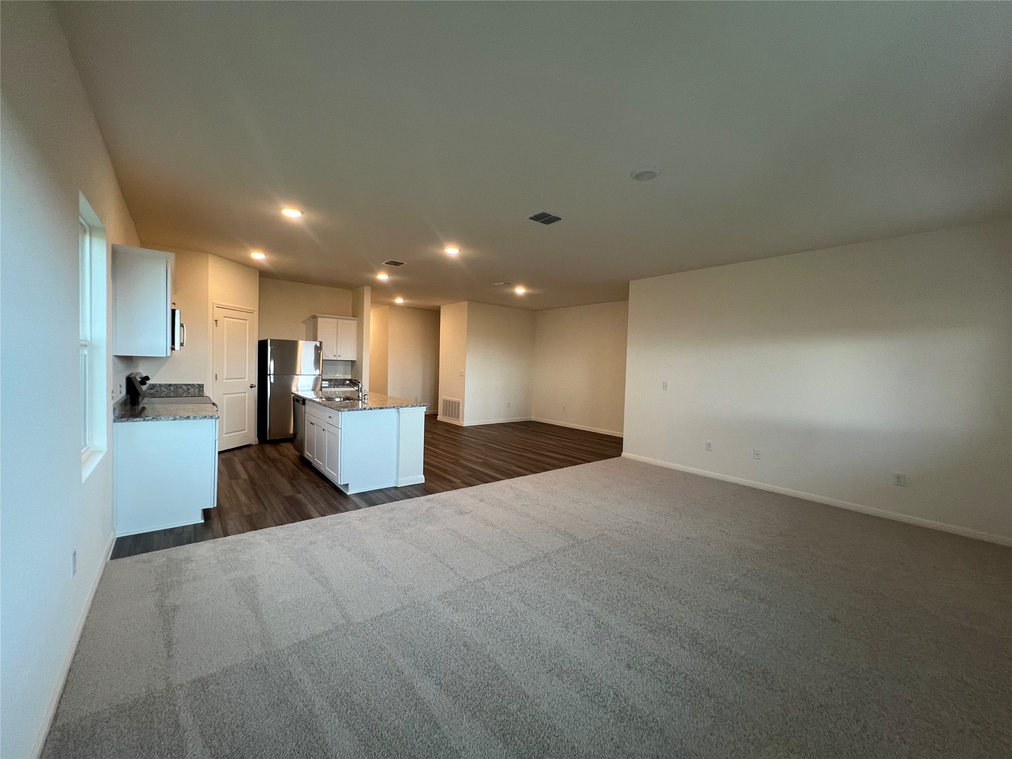 124 Rother Place Taylor, TX 76574 - Photo 12 of 12 An open floorplan seamlessly connects the well-appointed kitchen with the spacious living area.