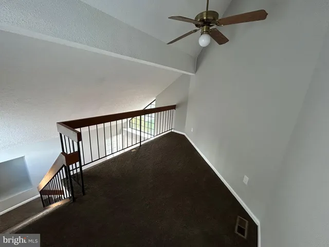 a view of a hallway with seating space
