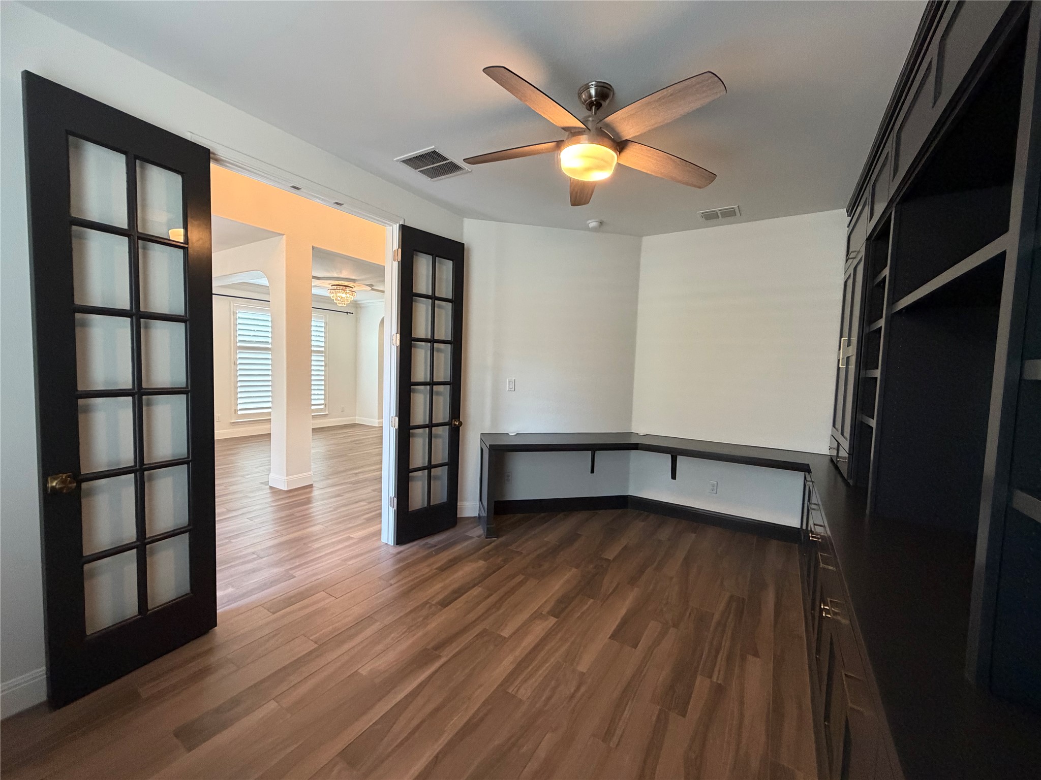 7801 Aria Loop Austin, TX 78736 - Photo 24 of 40 Main Floor Office Includes Stately Built-In Bookshelves and Desk and French Doors